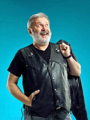 Sticker - Smiling middle-aged man happy expression posing in front of a blue studio background with copy space