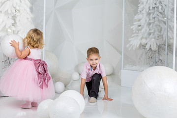 Portrait of happy children, little boy and girl, brother and sister celebrate Christmas. New Year's holidays.