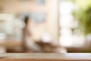 Wall Mural - Wooden desk with Blurred of coffe's shop for abstract background