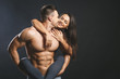© denis_vermenko - Sporty young happy sexy couple isolated over black background.