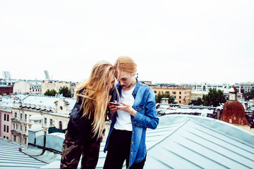 two cool blond real girls friends making selfie on roof top, lif