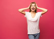© opolja - Image of happy young woman standing isolated over pink background. Looking camera pointing.