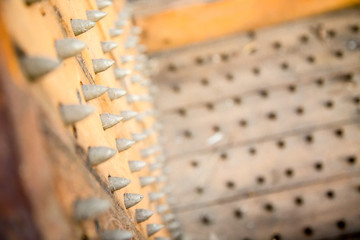 old wooden chair with spikes for torture