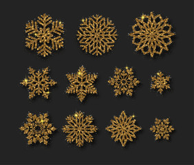 Set of beautiful shiny golden snowflakes isolated on black background.