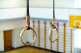 Fototapeta Krajobraz - Gymnastic ring hanging in gym. healthy lifestyle and fitness concept