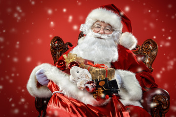 Poster - santa claus in armchair  with gifts