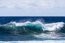 Wave Breaking Near Shore On South Point, On Hawaii's Big Island. Foam On Top Of Wave's Clear Blue-green Water; Deep Blue Pacific Ocean In The Background.  