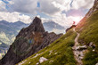 © J.M. Image Factory - Single Hiker on a Narrow Mountain Path in the Sunlight