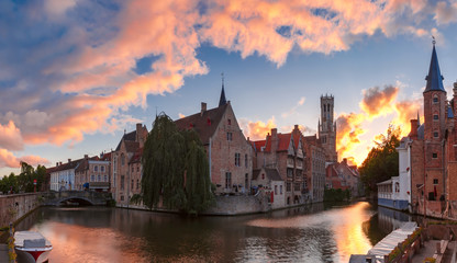 Scenic cityscape with tower Belfort and Church of Our Lady from the quay Rosary, Rozenhoedkaai, at sunset in Bruges, Belgium