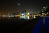 Fototapeta Sawanna - Long exposure night wide angle view of Marginal de Luanda with full moon and Mars moments after the beginning of lunar eclipse