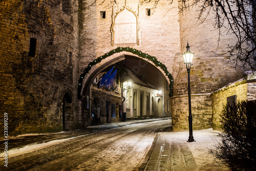 snow-covered-empty-street-at-night-old-town-of-tallinn-estonia