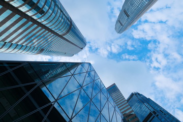 Skyscraper buildings for business and finance with reflection of blue sky