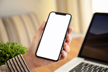 female hands holding touch phone with isolated screen in office