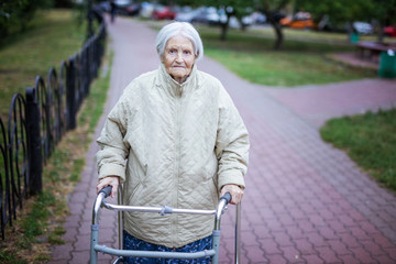 Attractive senior woman with walker outdoors