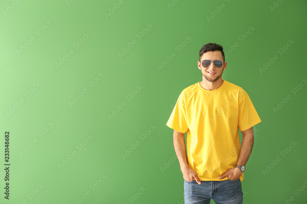 Young man in stylish t-shirt on color background