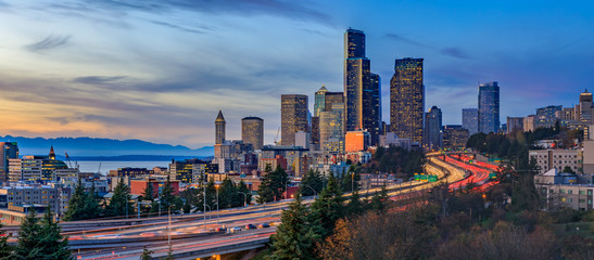 Seattle downtown skyline panorama at sunset from Dr. Jose Rizal or 12th Avenue South Bridge with traffic trail lights