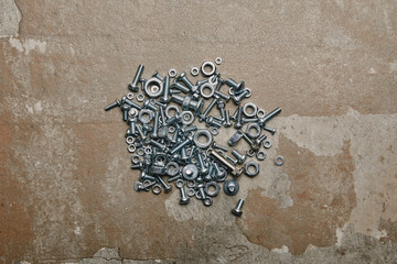 Wall Mural - Top view of screws and bolts arranged on the background of old  surface