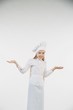 © Fotoproff - School-age girl dressed as a cook in white.