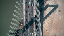 Aerial Top-down View Of Cars Moving Along Cable-stayed Bridge
