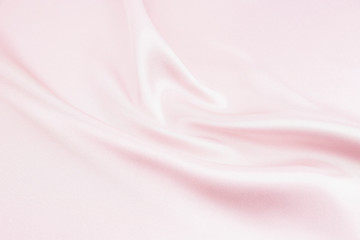 The texture of the satin fabric of pink color for the background 