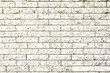© fewerton - Simple grungy white brick stone wall as seamless pattern texture background.