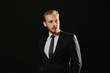 © Ирина Щукина - Young handsome brutal man in black suit cool hair style.Sexy businessman. Confident, elegant, stylish actor. Fashion shooting.