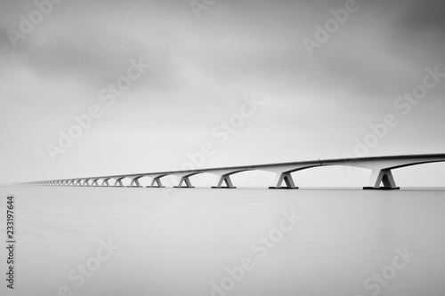 The Zeelandbrug (Zeeland Bridge) in the Dutch province of Zeeland, photographed in black & white, long exposure shot Tableau sur Toile