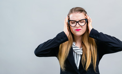 Wall Mural - Young woman feeling stressed on a gray background