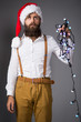 Man with a garland for Christmas fir
