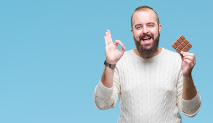 Young caucasian hipster man wearing sunglasses over isolated background cheerful with a smile of face pointing with hand and finger up to the side with happy and natural expression on face