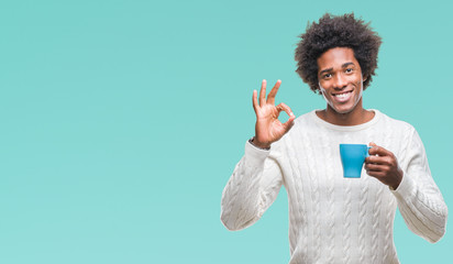 Poster - Afro american man drinking cup of coffee over isolated background doing ok sign with fingers, excellent symbol