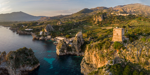  Aerial panorama of Scopello - faraglioni, tonnara and tower of Scopello. Beautiful panorama of touristic coastal village Scopello in Sicily, Italy. Beautiful mediterranean coast of Sicily, Italy..