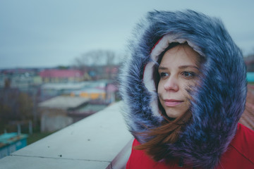 Girl posing on the street, a student in street clothes in the winter. street style. emotional portraits