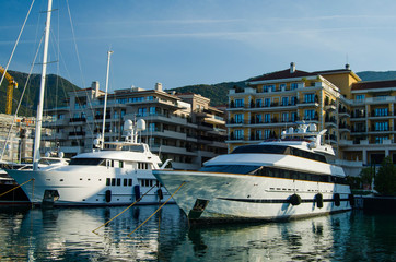 Large white yachts on the background of comfortable hotels.