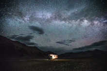 Camping Truck In Remote Tajik Mountain Landscape Under Starry Night Sky