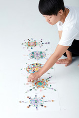 Mandala pattern with crystal and Asian women. a creator