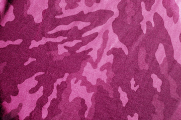 Old camouflage cloth with blur effect in pink tone.