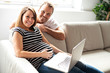 © Louis-Paul Photo - A Couple With Pregnant Woman Using Laptop Computer Together