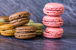 Concept sweets, enjoyment of the senses. Close up of French macaroons on a colorful background. Shallow depth of focus.