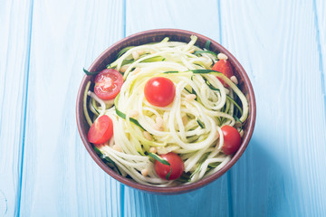 Zucchini pasta noodles with tomatoes . Healthy vegetarian food