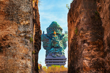 Landscape picture of Garuda Wisnu Kencana GWK statue as  Bali landmark with blue sky as a background. Balinese traditional symbol of hindu religion. Popular travel destinations in Indonesia.