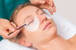 Eyelash care treatment procedures. Woman doing lashes lamination