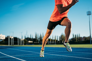 young athlete man starting to run in a start position in a race. start stride