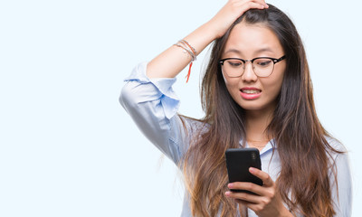 Sticker - Young asian woman texting using smartphone over isolated background stressed with hand on head, shocked with shame and surprise face, angry and frustrated. Fear and upset for mistake.