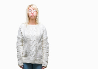 Poster - Young beautiful blonde woman wearing winter sweater and glasses over isolated background puffing cheeks with funny face. Mouth inflated with air, crazy expression.