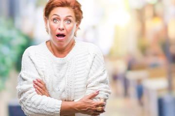 Sticker - Atrractive senior caucasian redhead woman wearing winter sweater over isolated background afraid and shocked with surprise expression, fear and excited face.