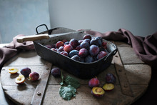 An Old Roasting Pan Full Of Fresh Plums