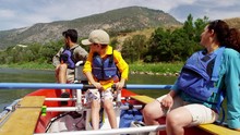 Happy American Caucasian Family Rafting On Colorado River On Holiday Outdoor