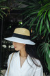 © LUMINA IMAGES - Portrait of a woman with summer hat.