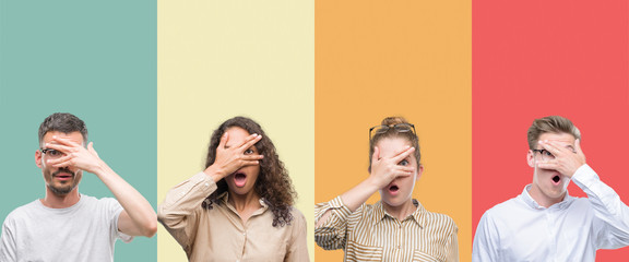 Wall Mural - Collage of a group of people isolated over colorful background peeking in shock covering face and eyes with hand, looking through fingers with embarrassed expression.